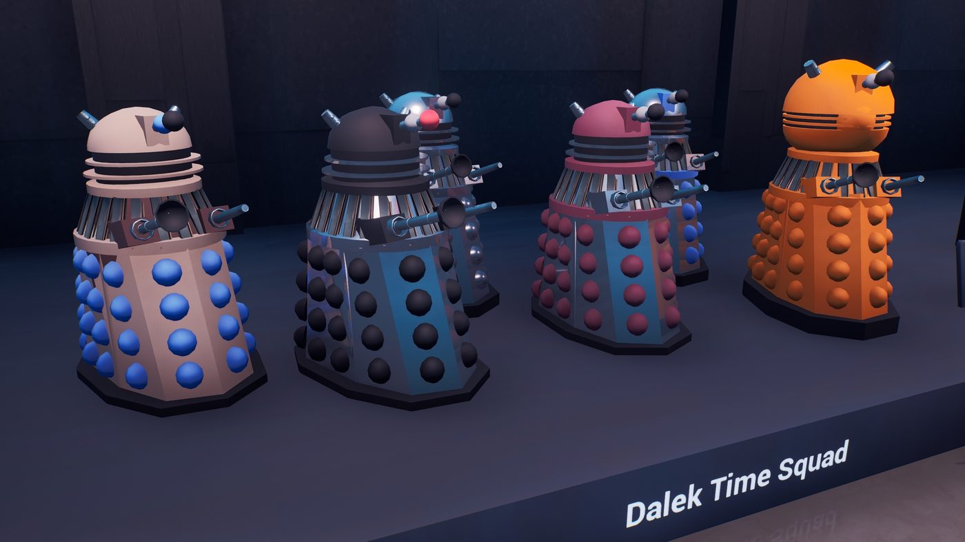 Four Daleks in different colors on a lit plinth, labelled Dalek Time Squad
